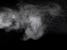 Abstract Design Of White Powder Cloud Against Dark Background