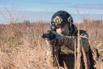 Wall Mural - Close up picture of airsoft soldier with a combat rifle outdoor