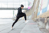 Fototapeta Młodzieżowe - Man athlete stretching and exercising outdoors