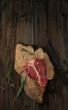 Raw Steak T-Bone with oregano and rosemary