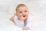 Baby in white bedding.