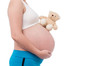 © bunwit - The belly asia pregnant woman holdind a teddy bear doll isolate