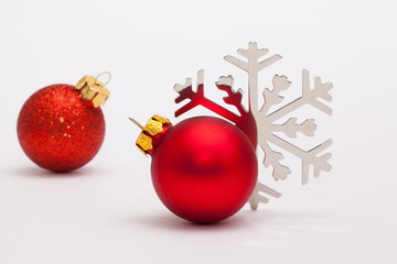 Red Christmas decoration and snowflake on the white desk