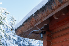 Wooden Log Thatched Roof Covered In Snow In Winter