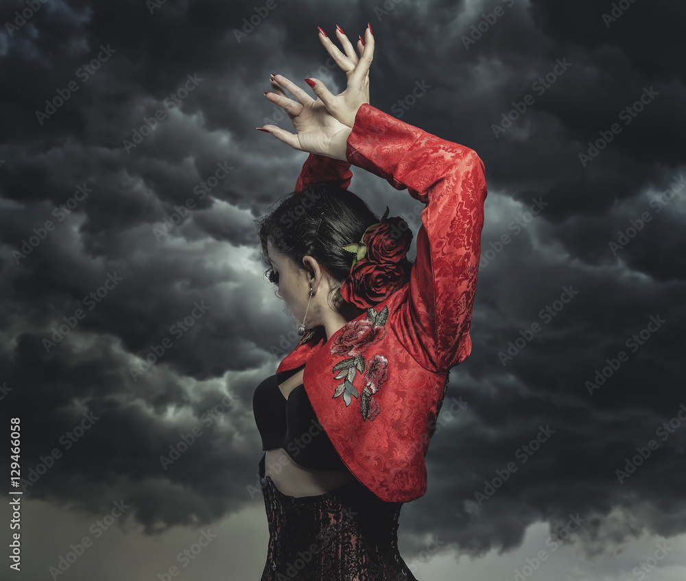 Spanish flamenco dancer with bun in hair and red coat with storm - obrazy, fototapety, plakaty 