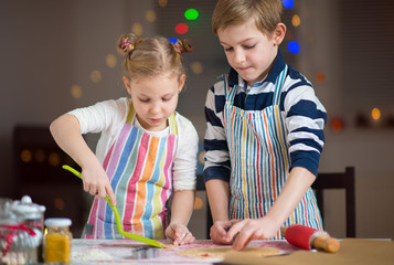 Happy  little children preparing Christmas cookies