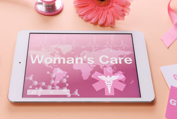 Wall Mural - Tablet with text WOMANS CARE on color background