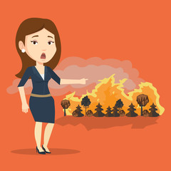 Canvas Print - Woman standing on background of wildfire.