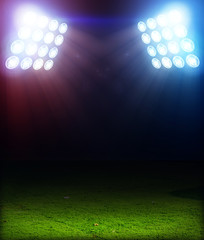 Wall Mural - Green soccer field, bright spotlights, illuminated stadium