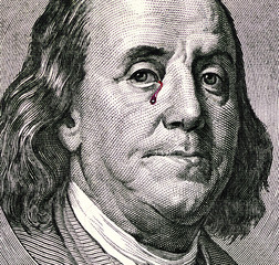 Benjamin Franklin's portrait on one hundred dollar bill. Franklin portrait with tears of blood. Franklin crying. Dollars close up.