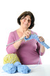 © Tseytlin - Happy elderly woman is engaged in knitting.