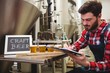 © WavebreakMediaMicro - Manufacturer writing on writing pad in brewery
