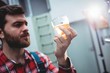 © WavebreakMediaMicro - Manufacturer holding beer glass at brewery