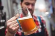 © WavebreakMediaMicro - Manufacturer examining beer at brewery