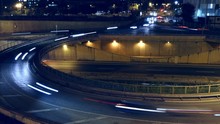Cinemagraph Of Roundabout Above Highway. Night Scene Urban Traffic, Of Barcelona, 
Underground Traffic In Motion And Static Traffic Surface.Time Lapse - Trail Effect - Long Exposure - Fixed Plane.

