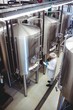 © WavebreakMediaMicro - Manufacturer standing amidst storage tanks at brewery