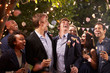 © Monkey Business - Smiling people celebrating wedding party in backyard