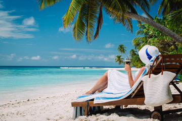 Wall Mural - woman drinking wine on tropical beach