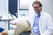© WavebreakMediaMicro - Male dentist interacting with female patient