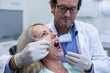 © WavebreakMediaMicro - Dentist examining a woman with tools