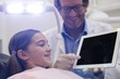 © WavebreakMediaMicro - Dentist showing digital tablet to young patient
