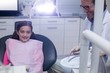© WavebreakMediaMicro - Smiling young patient sitting on dentists chair