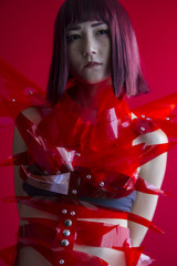 Oriental girl with red plastic costume, futuristic cosplay costu