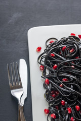 Sticker - Black pasta with pomegranate seeds