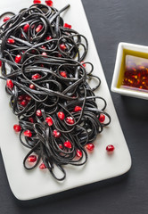 Sticker - Black pasta with pomegranate seeds