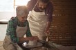 © WavebreakMediaMicro - Male potter assisting female potter