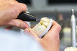 © mmphoto - Dentaltechniker bearbeitet Krone