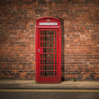 British Phone Box Against Red Brick Wall