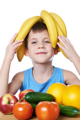 Wall Mural - Happy healthy boy with bananas and fruits isolated