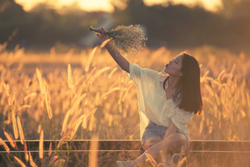 young beautiful woman sitting on railway with nature and fresh air happy.