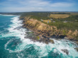 Aerial view of Cape Schanck Lighthose and waves crushing over rugged coastline in summer. Mornington Peninsula, Victoria, Australia