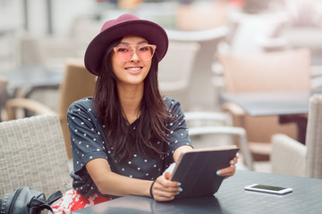 Wall Mural - Asian young woman working with mobile phone and tablet computer in cofe shop.