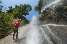 A Man Pauses To Smile For The Camera While Canyoning In A Waterfall, Nepal