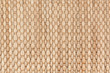 Bamboo woven beige mat handmade background. Wicker wood texture. Vertical strips.