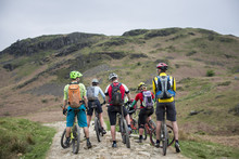 Mountain Bikers Stop To Consider Their Route Around Loughrigg Fell In The Lake District National Park, Cumbria