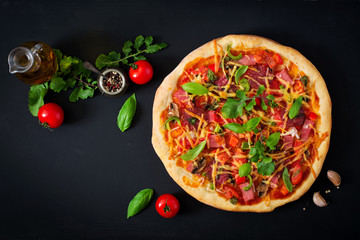 Wall Mural - Pizza with salami, ham, tomato, cheese and mushrooms. Top view