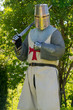 A person dresses up historically to mimic a knights templar in full armour