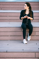 Wall Mural - Fit woman listening music.