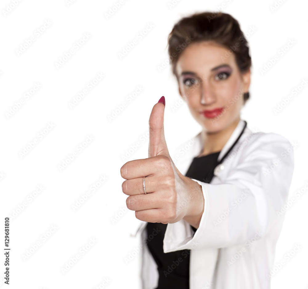 young woman doctor showing thumbs up on a white background Stock Photo ...