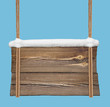 Wooden signboard with snow hanging on double ropes