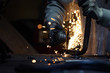 © skinfaxi - Worker cutting metal pipe using angular grinding machine. Horizontal photo.