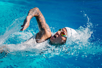  Female front crawl swimmer with tattoos