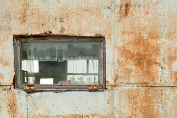 Wall Mural - Old window with wooden frame on a background of rusty metal wall