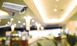 CCTV Camera on abstract blur beautiful hotel lobby background for design.