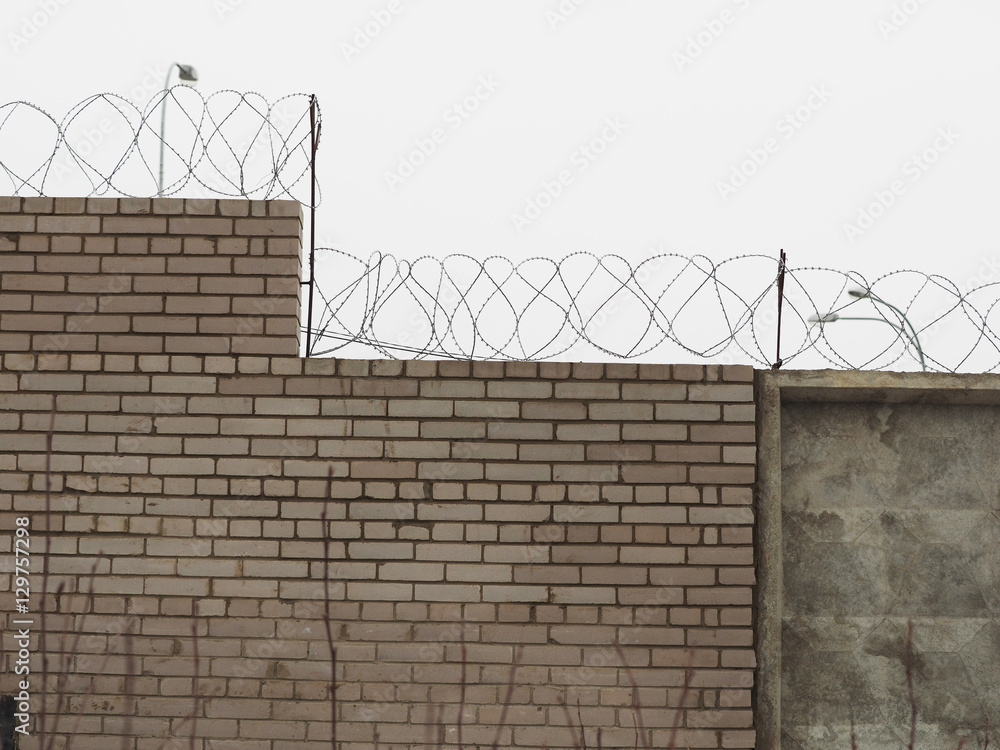 brick fence with barbed wire Stock Photo | Adobe Stock