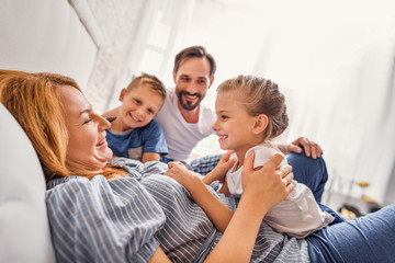 Happy family of four at home